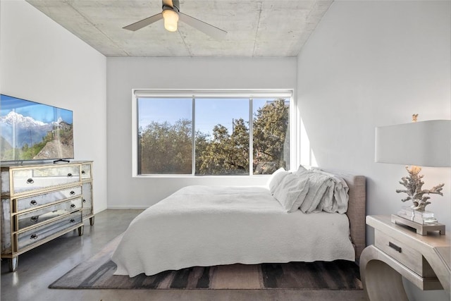 bedroom with concrete floors and ceiling fan