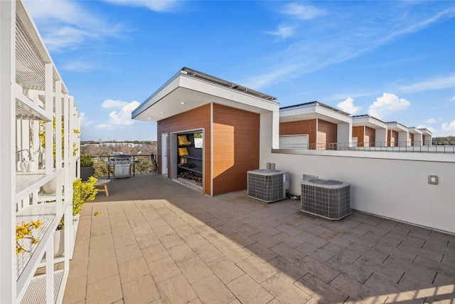 view of patio / terrace with grilling area, central AC, and fence