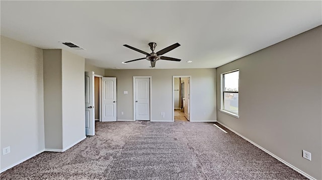 unfurnished bedroom with carpet, visible vents, and baseboards