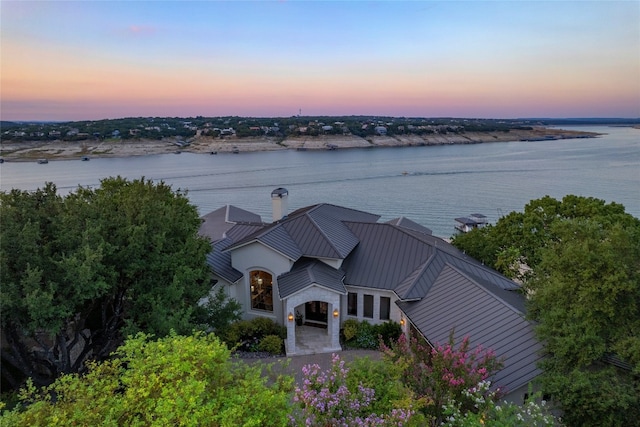 aerial view at dusk with a water view