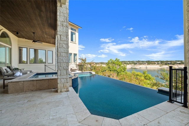 view of swimming pool with a water view, a patio, an in ground hot tub, an infinity pool, and a ceiling fan