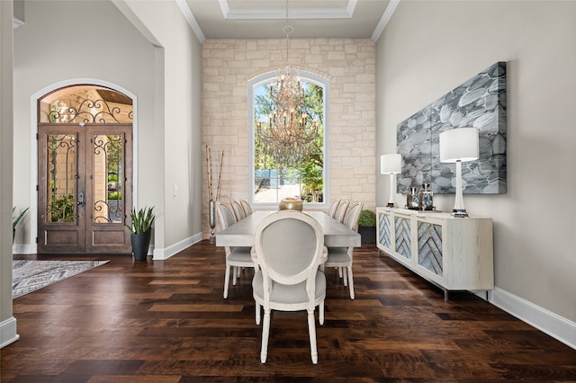 711 Cutlass, Lakeway, TX 78734 - dining room with a chandelier, crown molding, and dark wood-style flooring