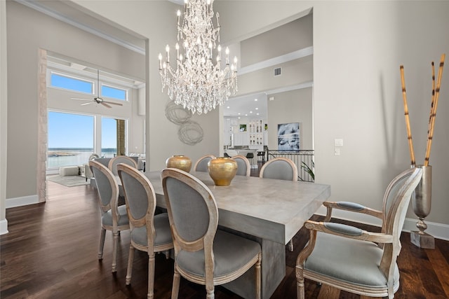 dining room with baseboards, a high ceiling, dark wood-style flooring, and ceiling fan with notable chandelier