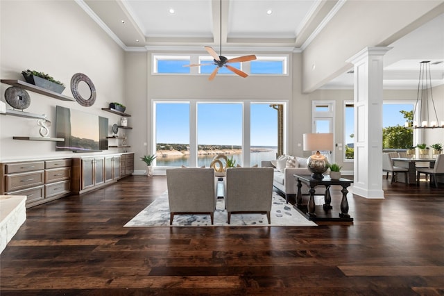 711 Cutlass, Lakeway, TX 78734 - dining area with decorative columns, ceiling fan, ornamental molding, dark wood-style floors, and a high ceiling