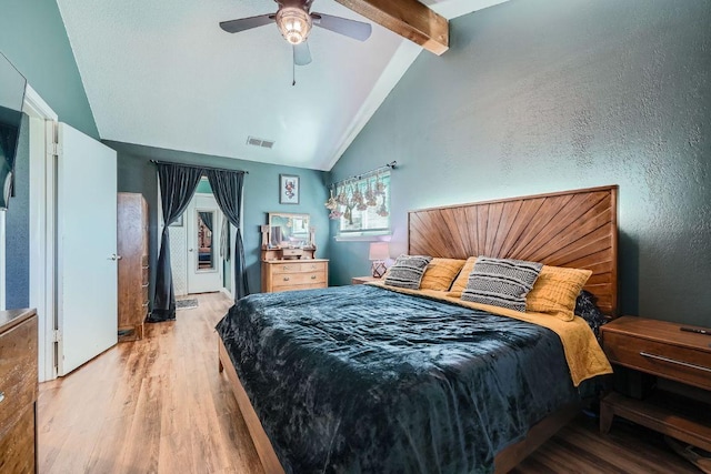 bedroom featuring visible vents, light wood finished floors, lofted ceiling with beams, ceiling fan, and access to outside