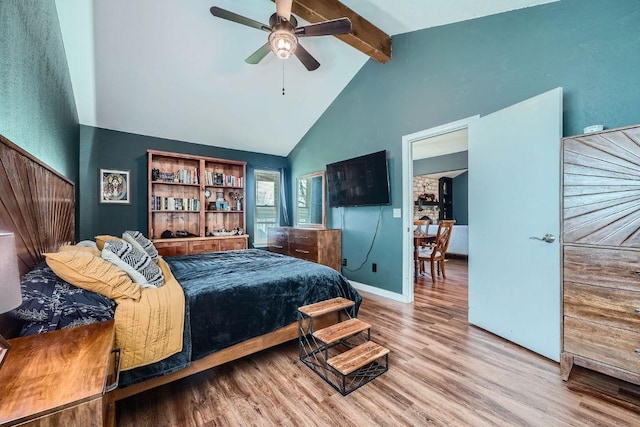 bedroom with beamed ceiling, high vaulted ceiling, wood finished floors, baseboards, and ceiling fan