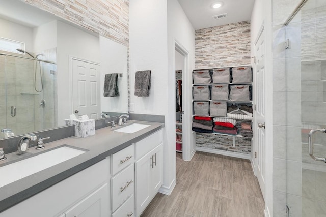 full bath with a sink, visible vents, and a shower stall