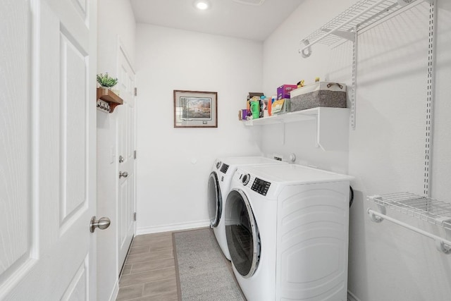 washroom with washer and dryer, recessed lighting, laundry area, baseboards, and wood tiled floor