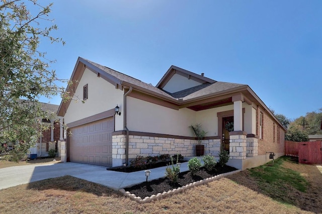 7505 Albany Dr, Austin, TX 78754 - view of front of home featuring stucco siding, driveway, stone siding, and a garage
