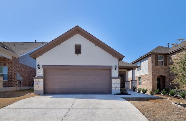 view of front of property with concrete driveway, a garage, stone siding, and stucco siding