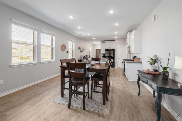 dining room with recessed lighting, baseboards, and light wood-style flooring