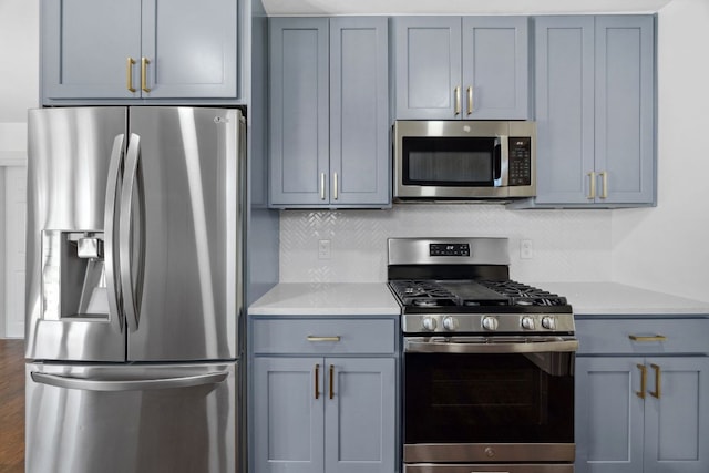 kitchen with light countertops, gray cabinetry, and appliances with stainless steel finishes