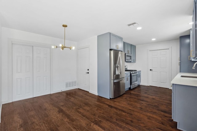 kitchen featuring a sink, stainless steel appliances, visible vents, and light countertops