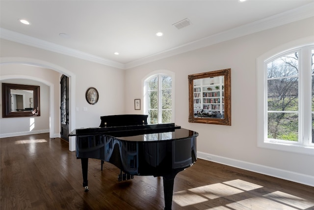 living area featuring visible vents, dark wood-type flooring, recessed lighting, crown molding, and baseboards