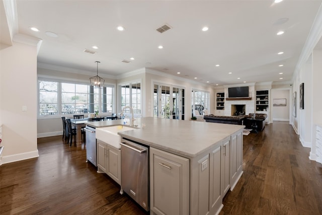 kitchen featuring dishwasher, dark wood finished floors, a wealth of natural light, and ornamental molding