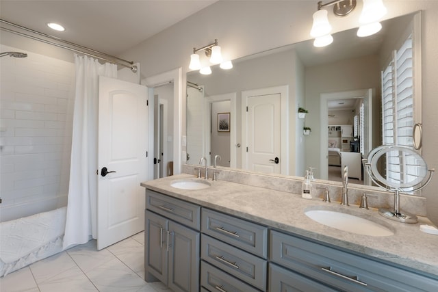 full bathroom with a shower with curtain, marble finish floor, and a sink