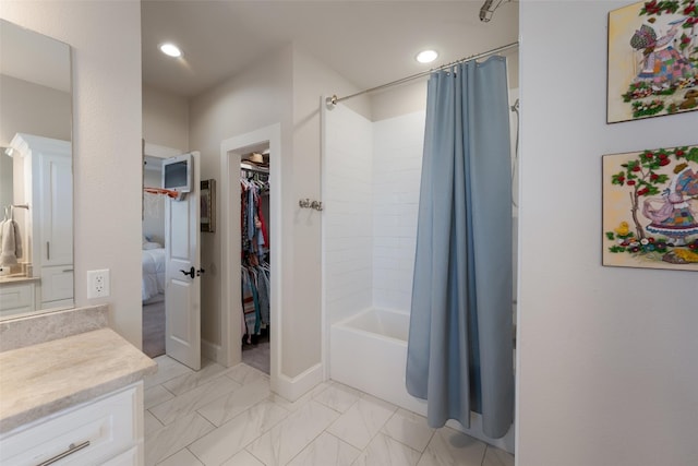 bathroom with marble finish floor, recessed lighting, vanity, and shower / tub combo with curtain