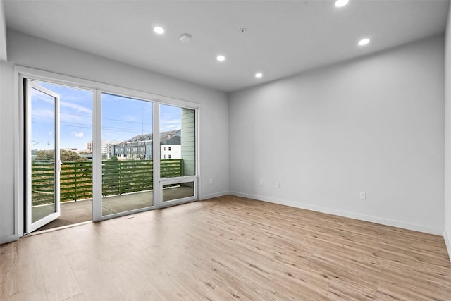 unfurnished room featuring recessed lighting, light wood-style floors, and baseboards