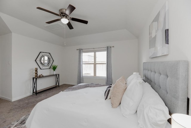 carpeted bedroom with visible vents, baseboards, a raised ceiling, and ceiling fan