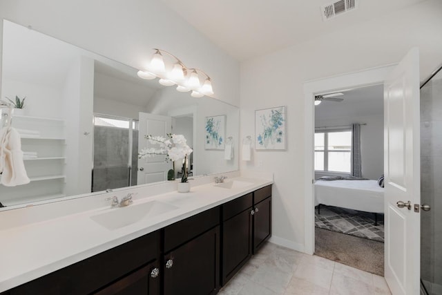 bathroom featuring double vanity, visible vents, a shower stall, and a sink