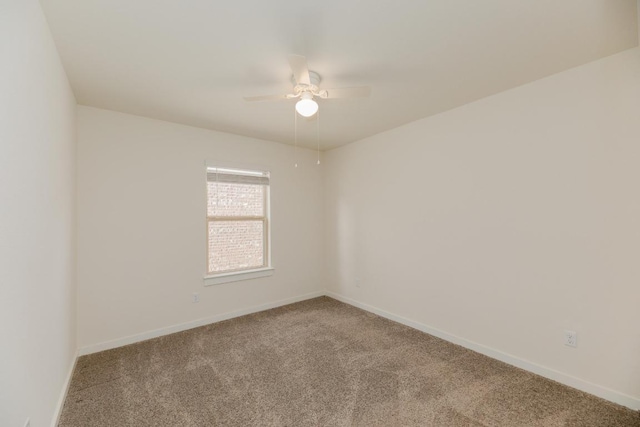 empty room featuring baseboards, carpet, and a ceiling fan