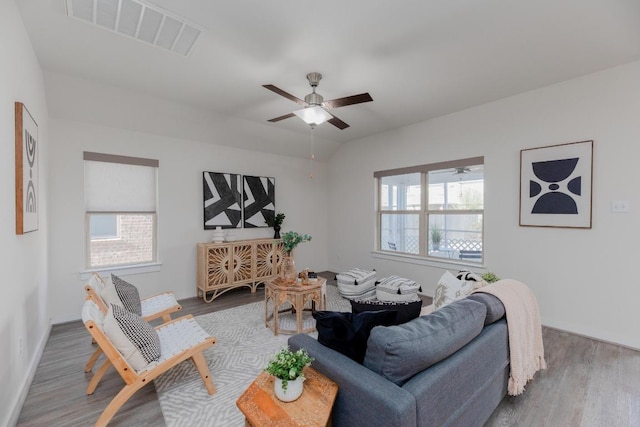 living area with plenty of natural light, wood finished floors, and visible vents