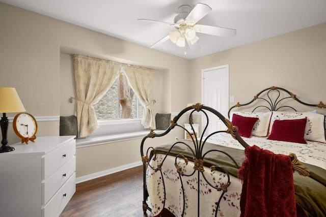 bedroom featuring ceiling fan, baseboards, and wood finished floors