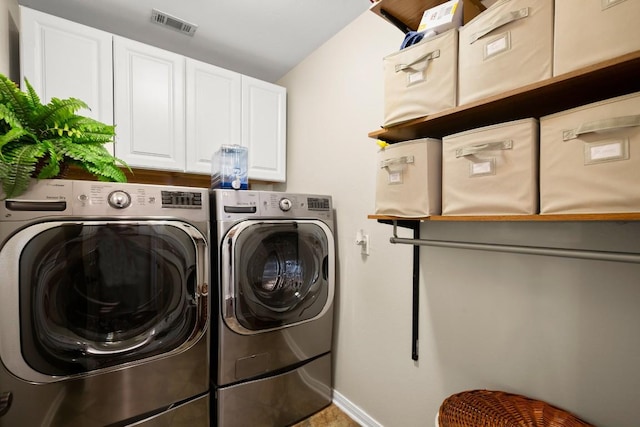 laundry room featuring visible vents, cabinet space, baseboards, and washing machine and dryer