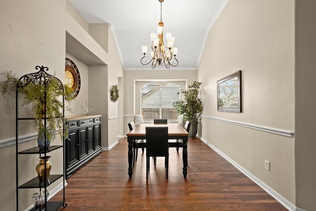 dining area featuring an inviting chandelier, dark wood-style floors, baseboards, and ornamental molding