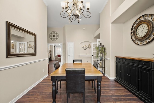 dining space with a chandelier, baseboards, dark wood-type flooring, and ornamental molding