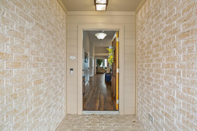 view of exterior entry featuring brick siding