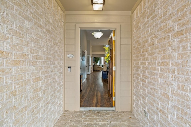 view of exterior entry with brick siding