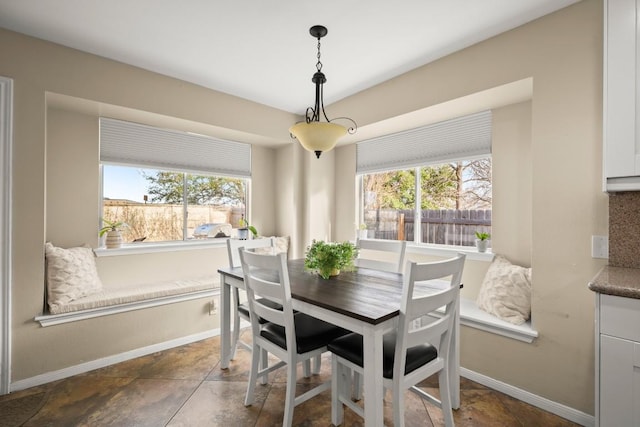 dining area with a wealth of natural light and baseboards