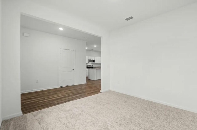 1424 Morris Loop, San Marcos, TX 78666 - unfurnished room with recessed lighting, dark colored carpet, baseboards, and dark wood-type flooring