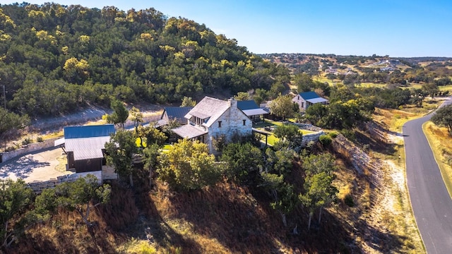 drone / aerial view with a wooded view