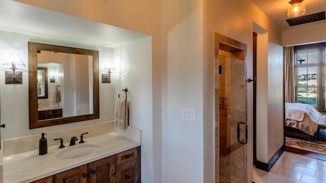 bathroom with visible vents, vanity, a stall shower, and ensuite bathroom