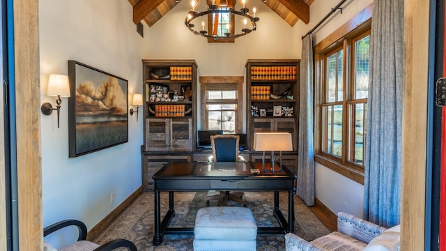 home office with a notable chandelier, lofted ceiling with beams, baseboards, and wood finished floors