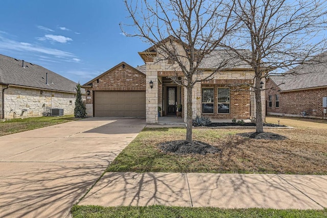 view of front of home with a garage, brick siding, central AC unit, and concrete driveway