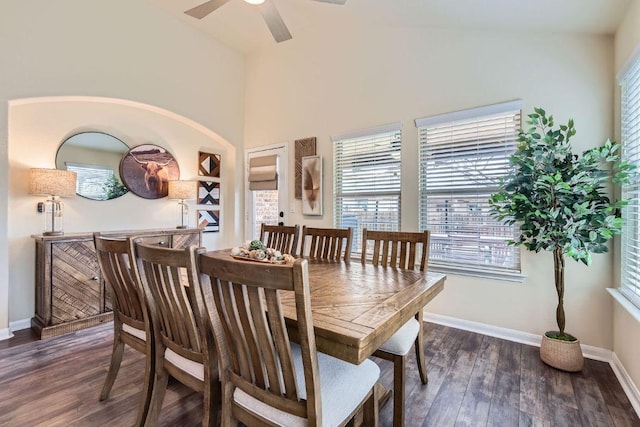 dining space featuring a ceiling fan, wood finished floors, baseboards, and high vaulted ceiling