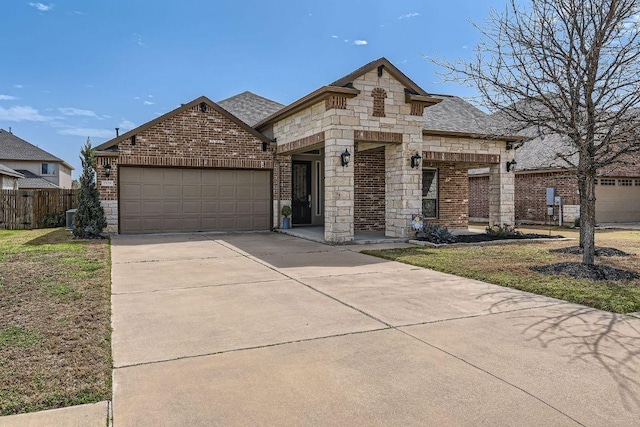 french provincial home with brick siding, an attached garage, concrete driveway, and fence