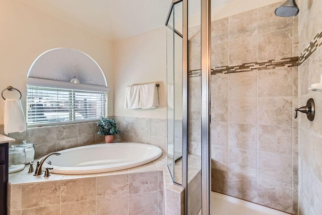 bathroom with a bath and a shower stall