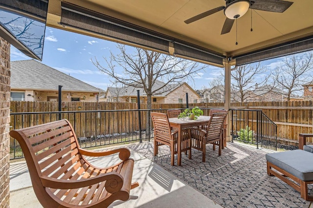 view of patio featuring a fenced backyard, outdoor dining area, and a ceiling fan