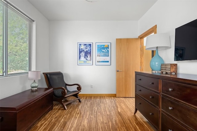 sitting room with light wood-style floors and baseboards