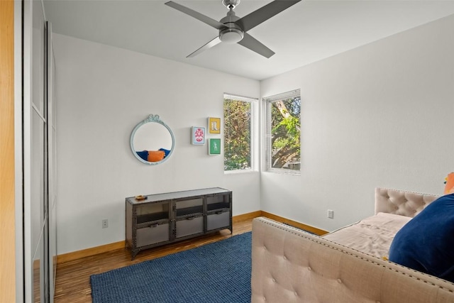 bedroom featuring wood finished floors, baseboards, and ceiling fan