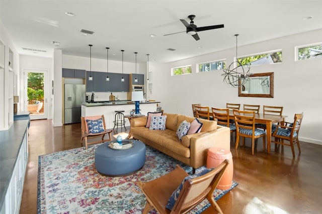 303 W Annie St, Austin, TX 78704 - living room with finished concrete flooring, ceiling fan, a chandelier, baseboards, and recessed lighting