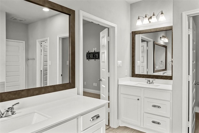 full bathroom featuring vanity and wood finished floors