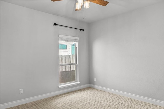 empty room with carpet, baseboards, and ceiling fan