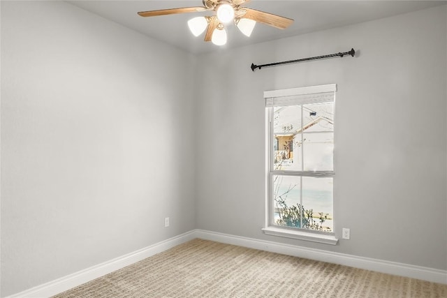 carpeted empty room with baseboards and ceiling fan