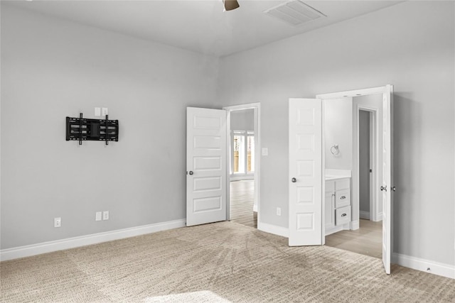 unfurnished bedroom with a ceiling fan, baseboards, visible vents, and light carpet