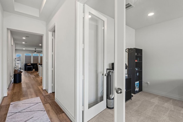 hall featuring recessed lighting, baseboards, and wood finished floors